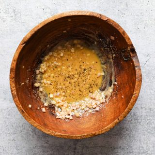Lemon-Dijon vinaigrette in a wooden salad bowl