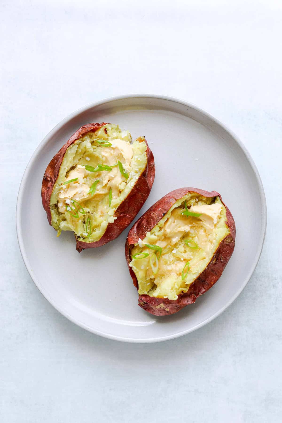two roasted Japanese sweet potatoes with miso-butter and scallion