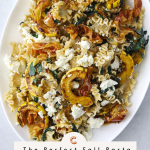a white oval platter filled with pasta, goat cheese, roasted squash, and crispy pancetta