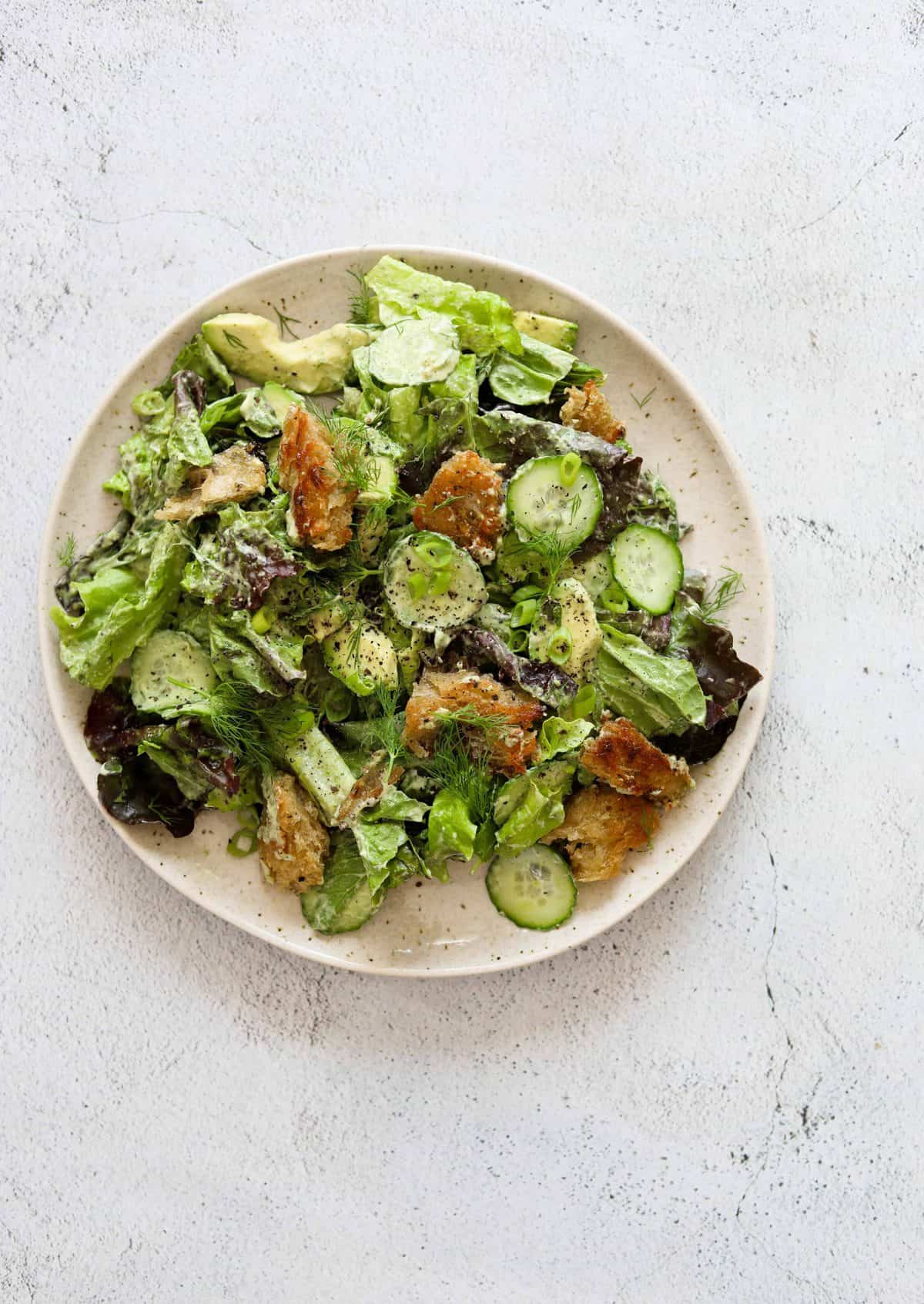 Green Goddess Salad with Basil-Tahini Dressing on a white plate
