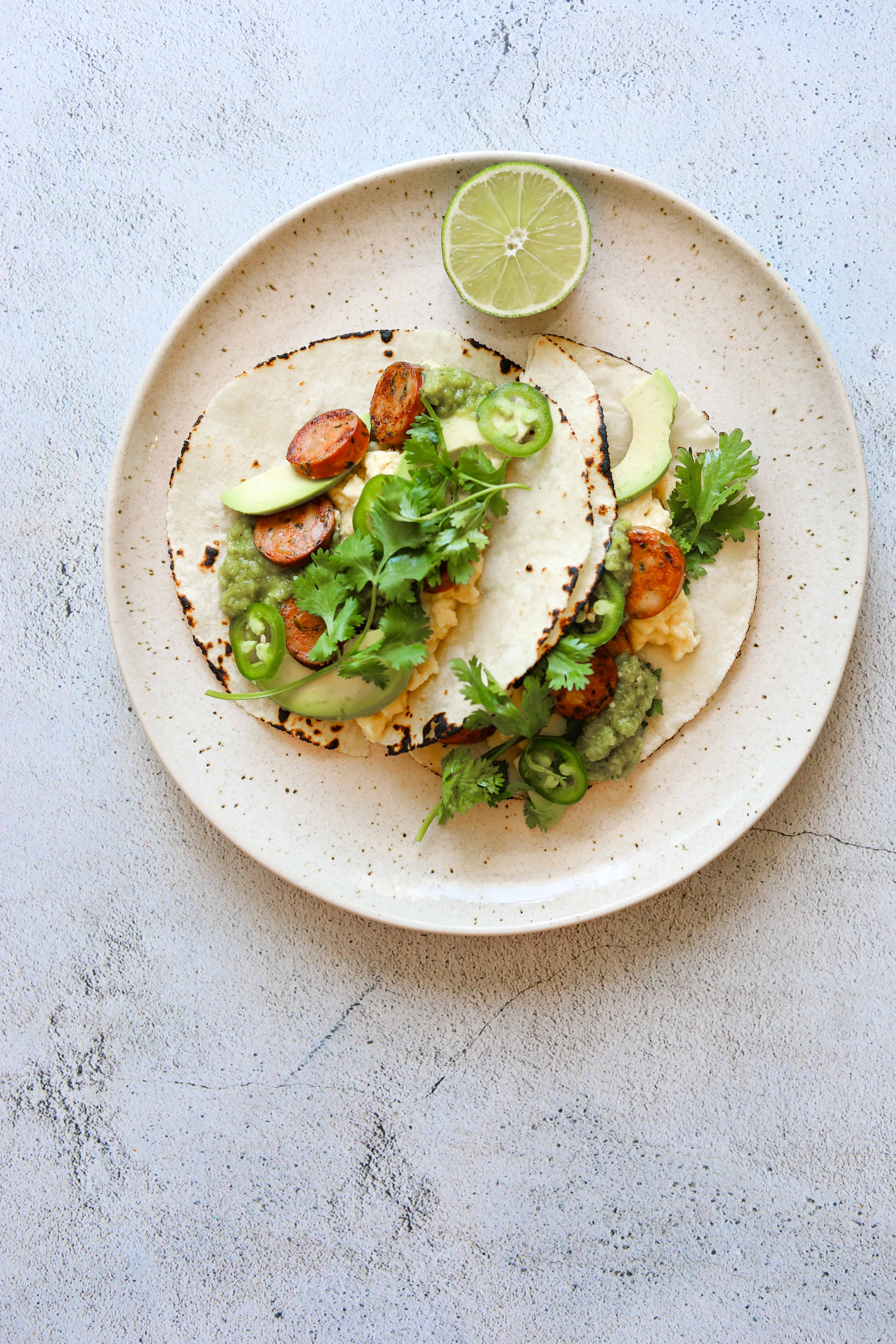 Paleo Breakfast Tacos on a plate with a slice of lime