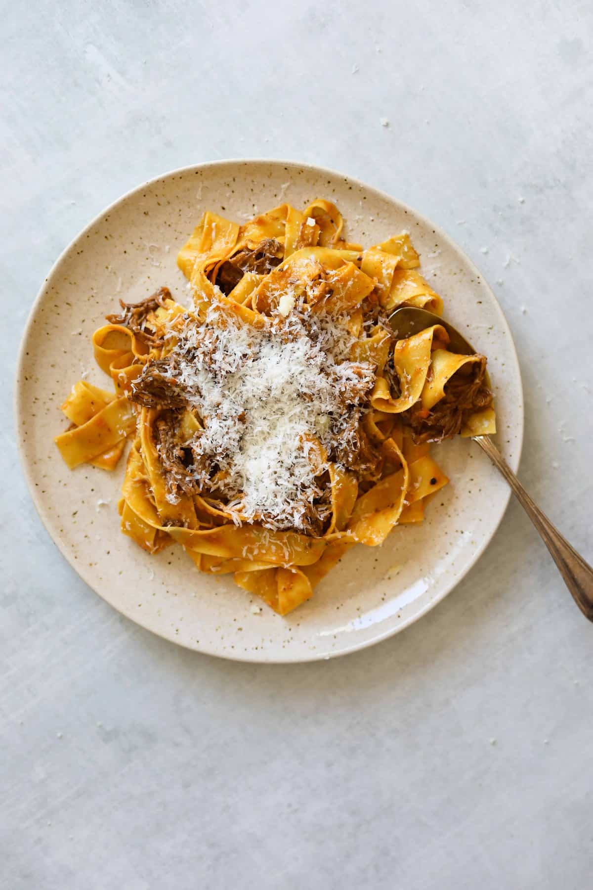 Short Rib Ragu with Pappardelle on a plate with a spoon