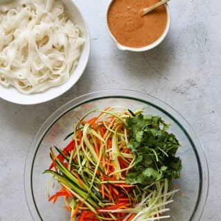 Creamy Coconut Thai Noodle Salad ingredients in a bowl with the sauce on the side