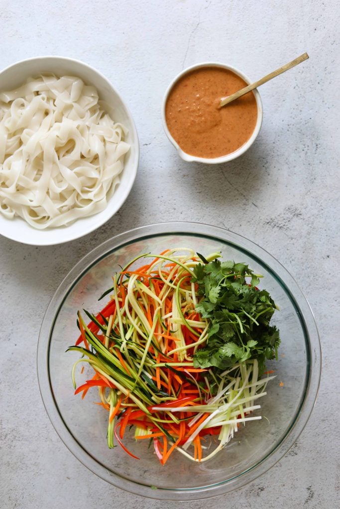 Creamy Coconut Thai Noodle Salad ingredients in a bowl with the sauce on the side