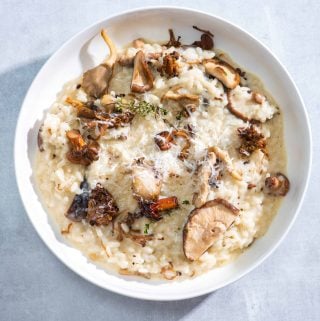 Creamy Roasted Mushroom Risotto with Truffle Oil in a white bowl