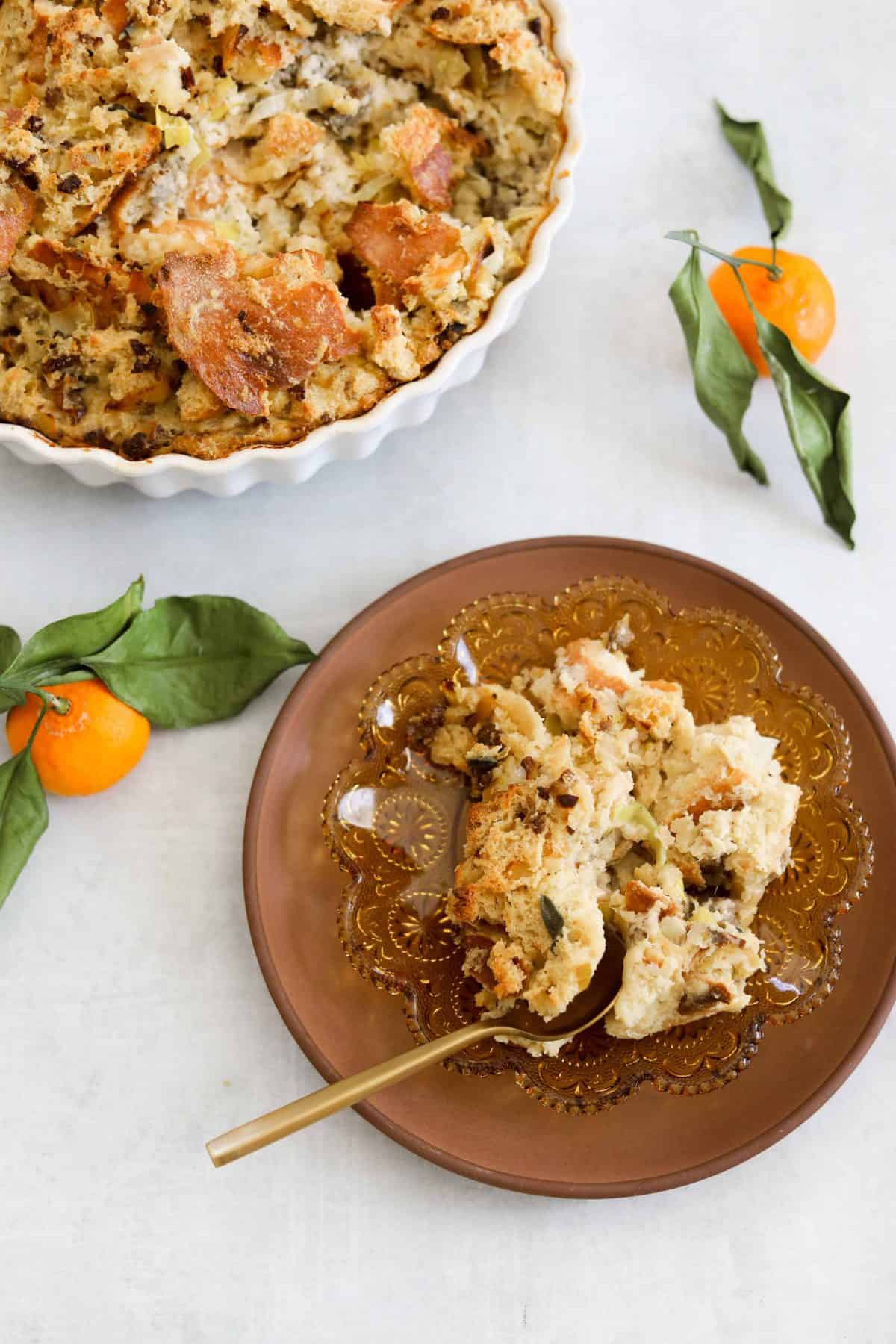 Savory Bread Pudding with Sausage + Sage being served on small brown plates.