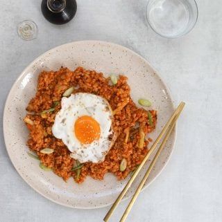 Kimchi Brown Rice Breakfast Bowl on a Blue Background
