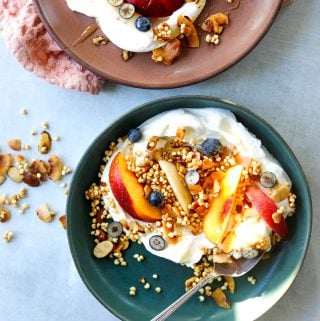 Two bowls of greek yogurt and millet granola