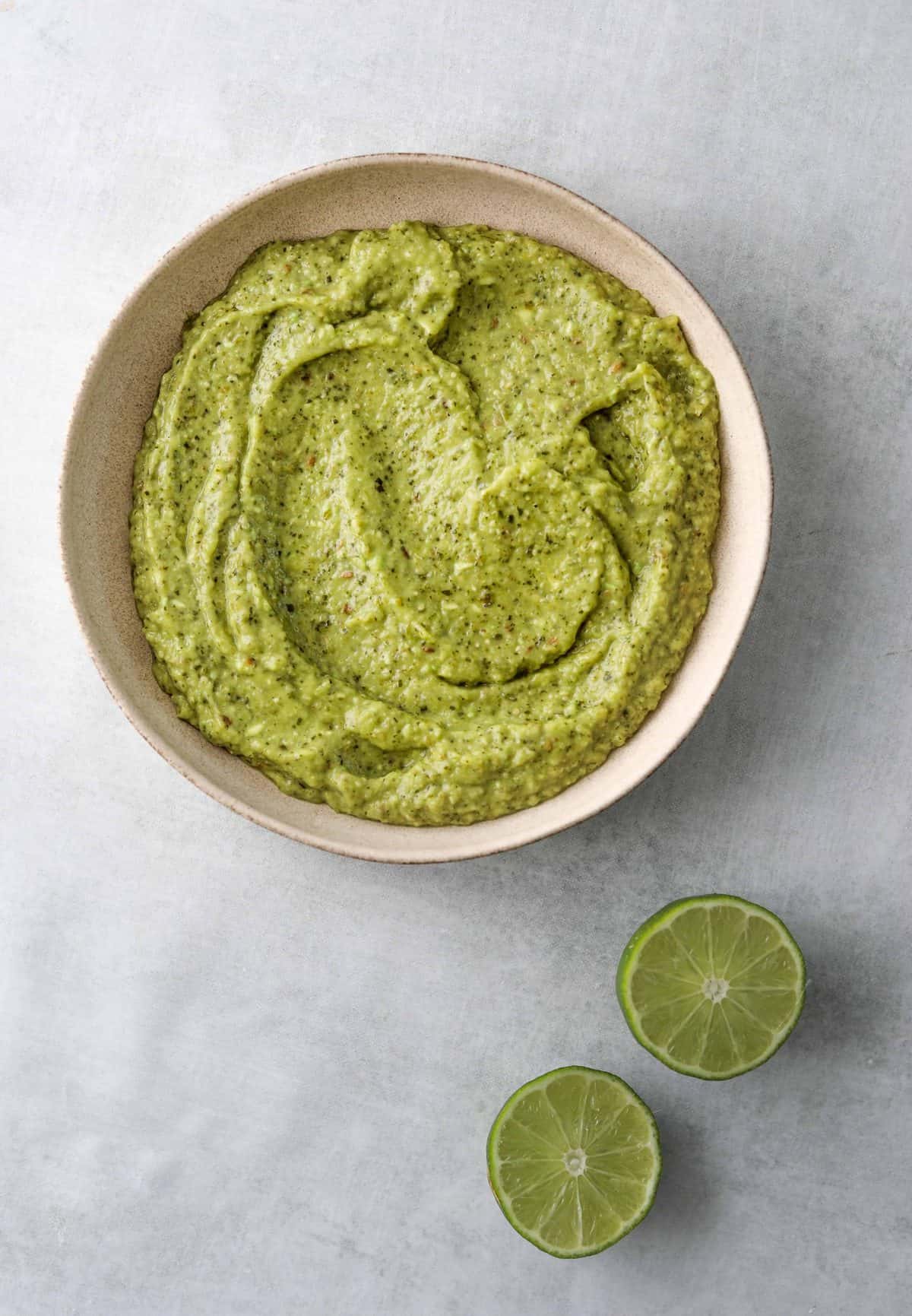creamy avocado salsa in a white bowl