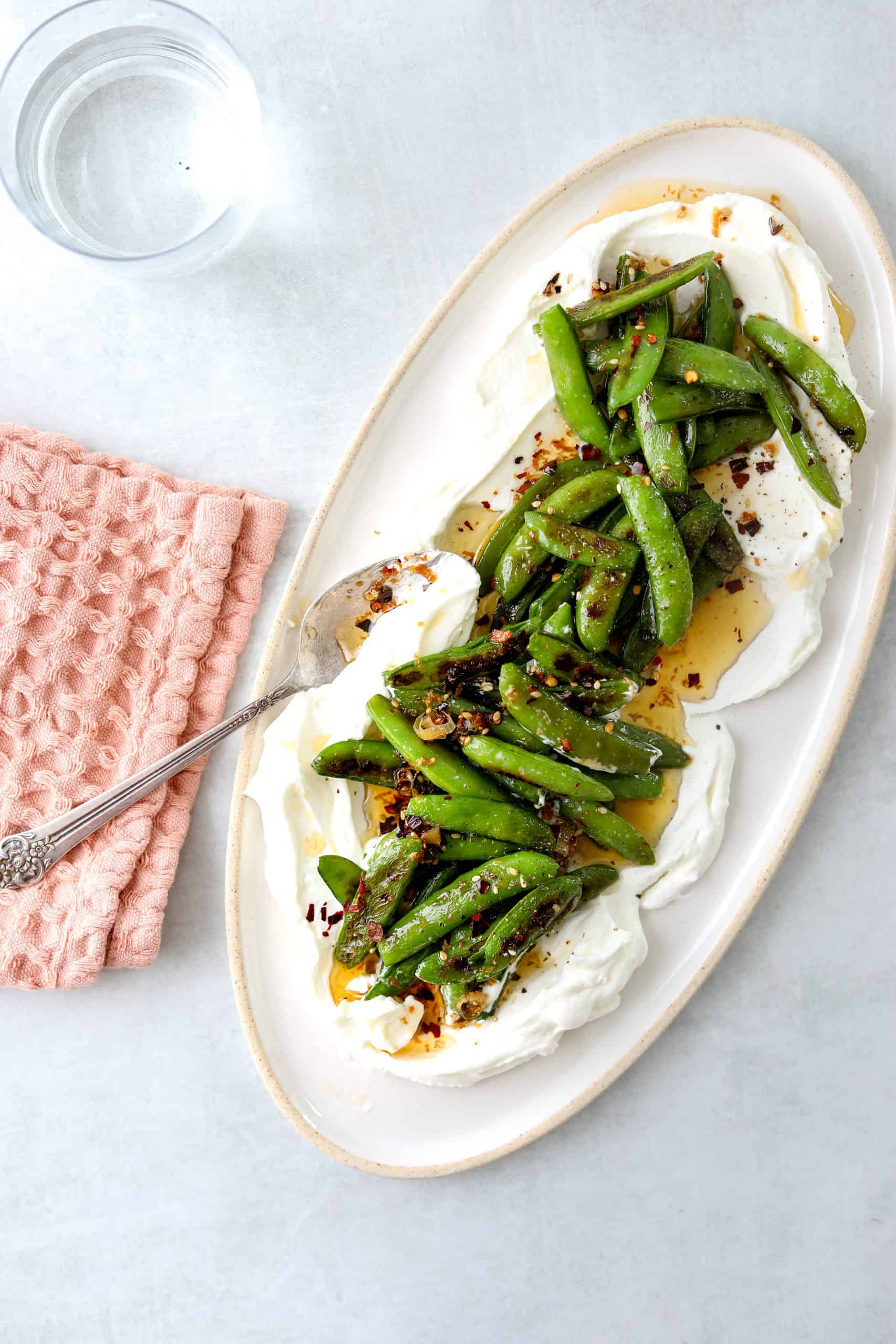 a platter with Roasted Snap Peas with Yogurt and Garlic Chili Oil