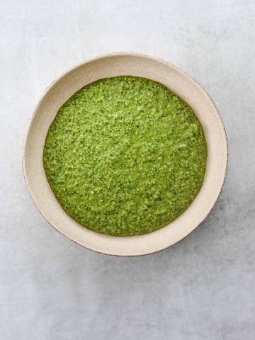 a bowl of bright green Arugula and Walnut Pesto