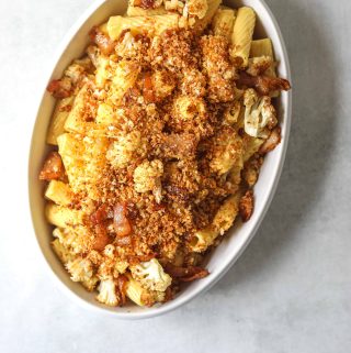 a white oval serving dish filled with Roasted Cauliflower Carbonara with Garlic Breadcrumbs