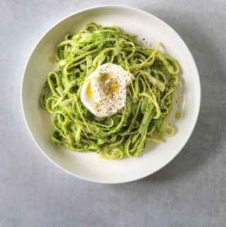 a white bowl filled with Tagliatelle with Pea Pesto and Creme Fraiche