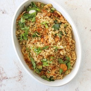a white oval serving dish filled with Quinoa Fried "Rice" with Crispy Garlic and Ginger