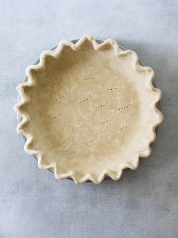 flakey pie crust dough in a pie tin