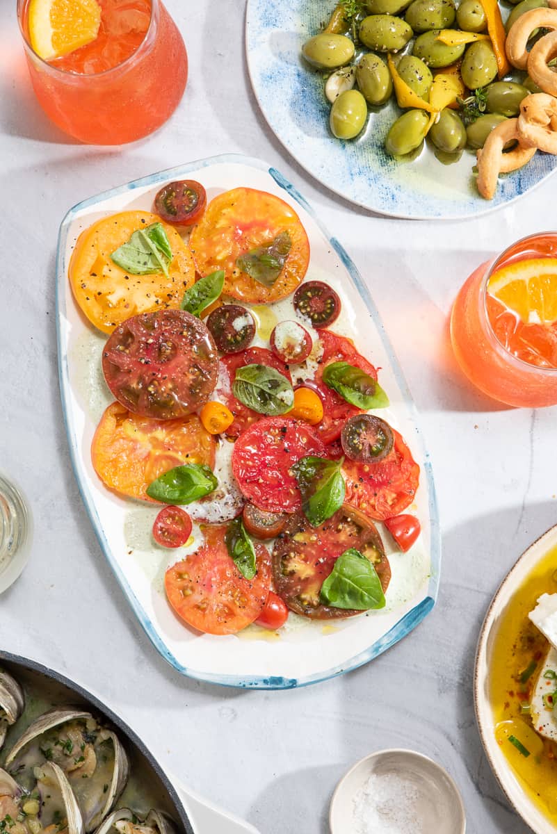 a platter filled with heirloom tomato salad with buttermilk-basil dressing