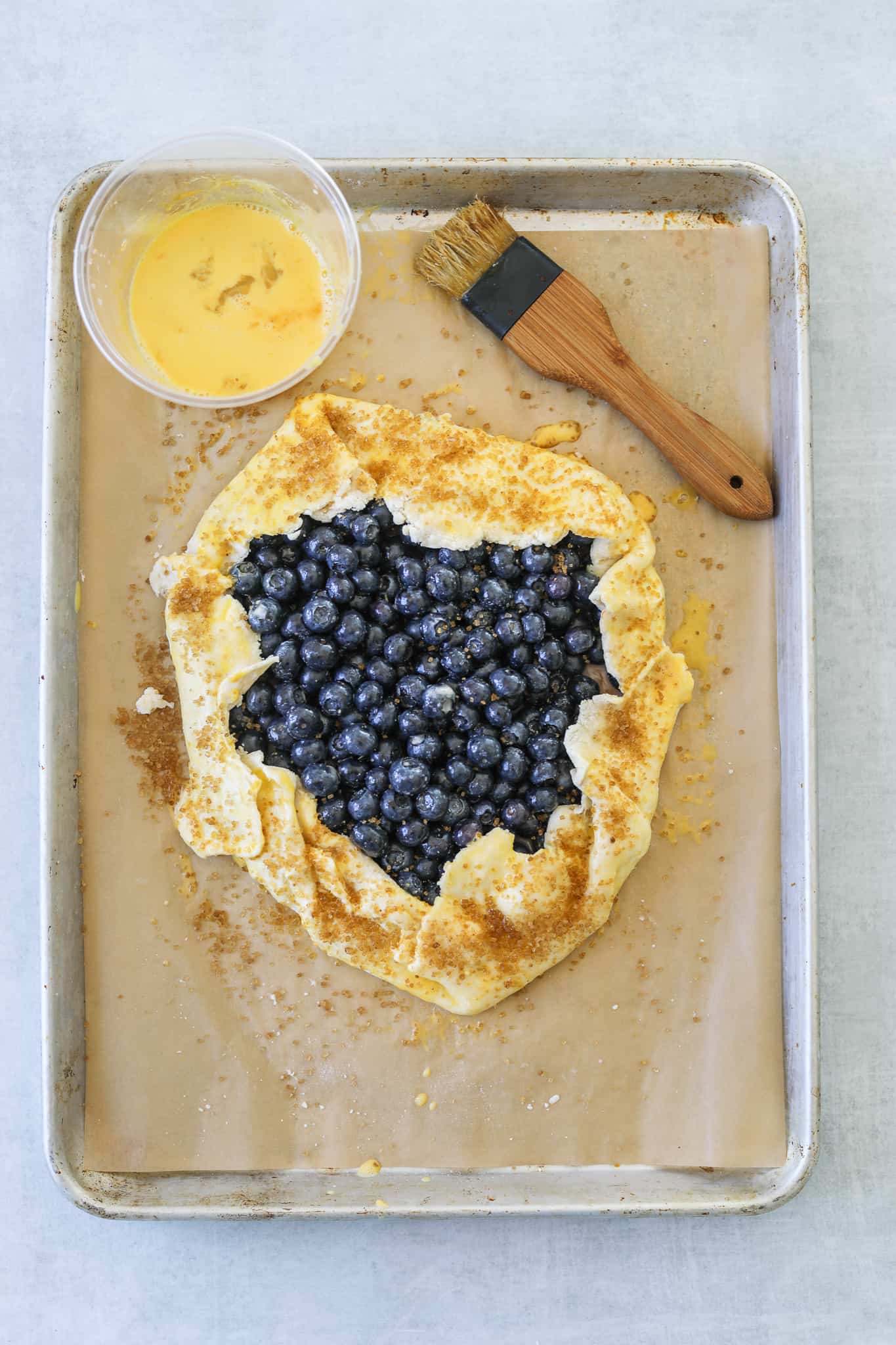 uncooked blueberry galette on a baking tray