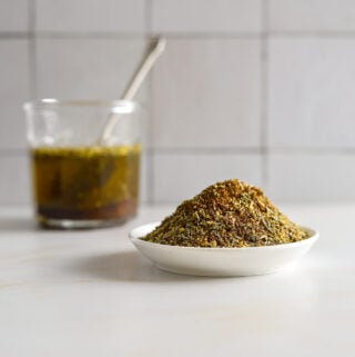 A small white dish with a tall pile of spices.