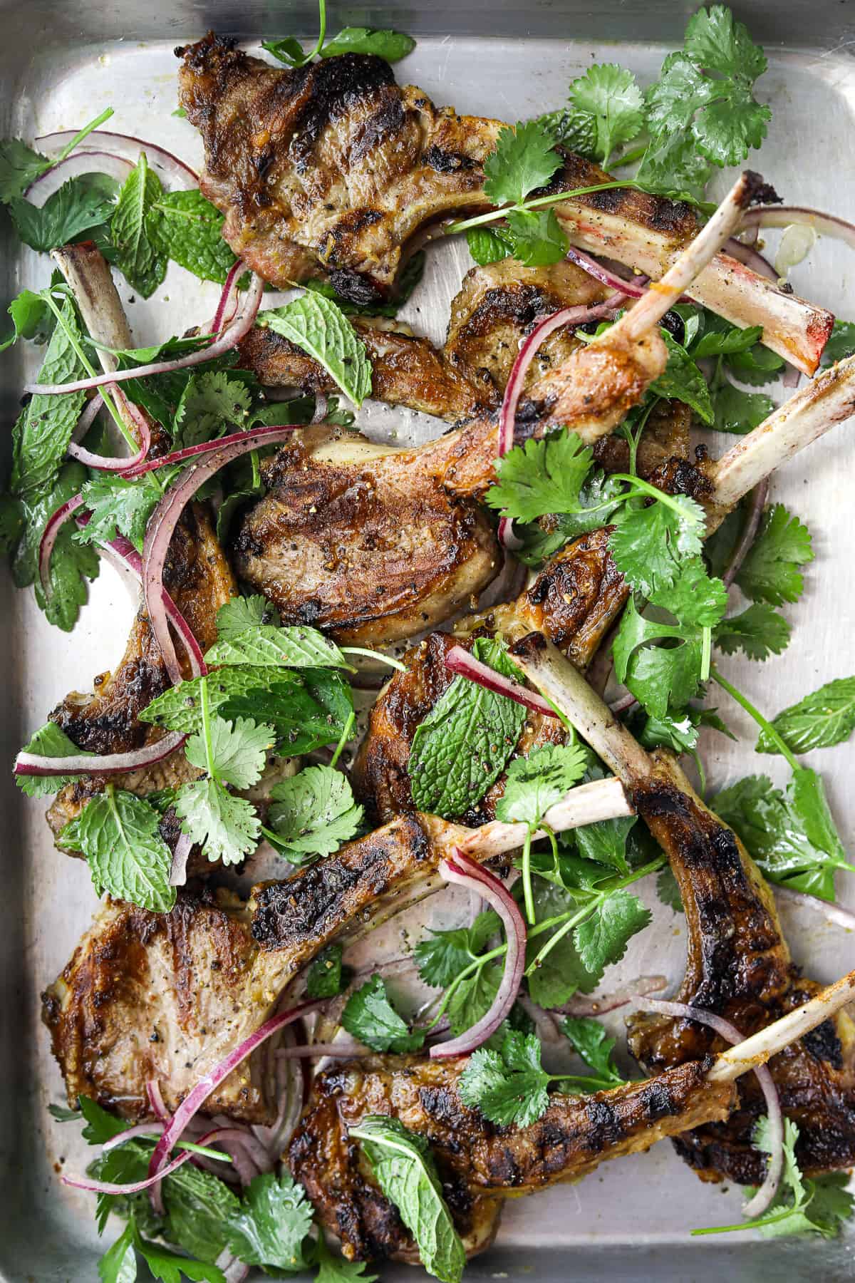 a metal sheet pan with Grilled Lamb Chops with Herb Salad