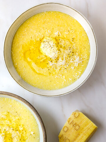 a bowl of polenta topped with butter and parmesan cheese