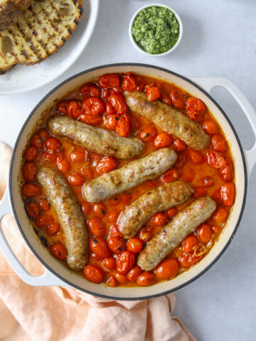 tomatoes and sausages in a pot