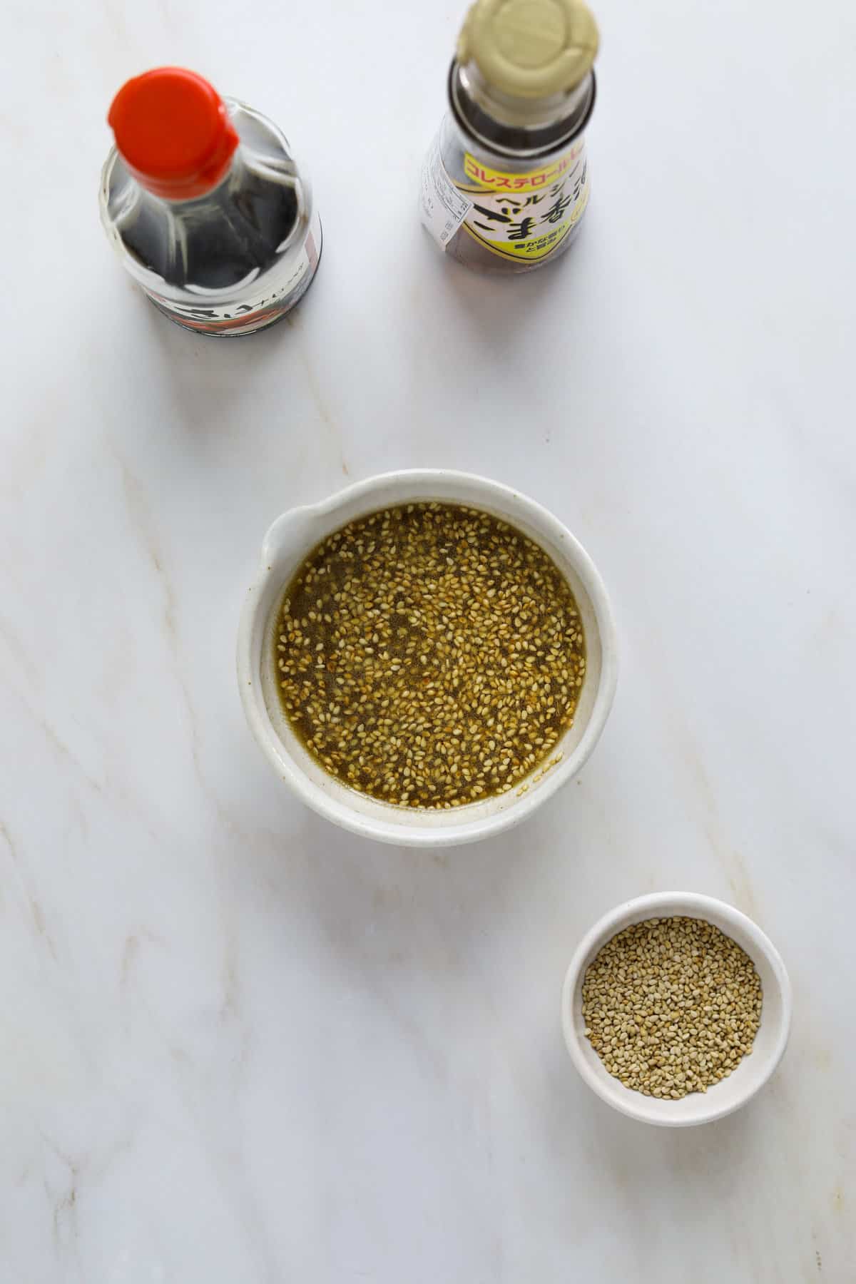 Sesame salad dressing in a small spouted bowl.