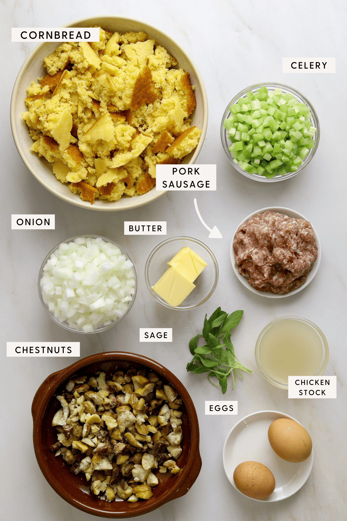 Stuffing ingredients in individual bowls; chopped chestnuts, eggs, chicken stock, diced celery and onion etc.