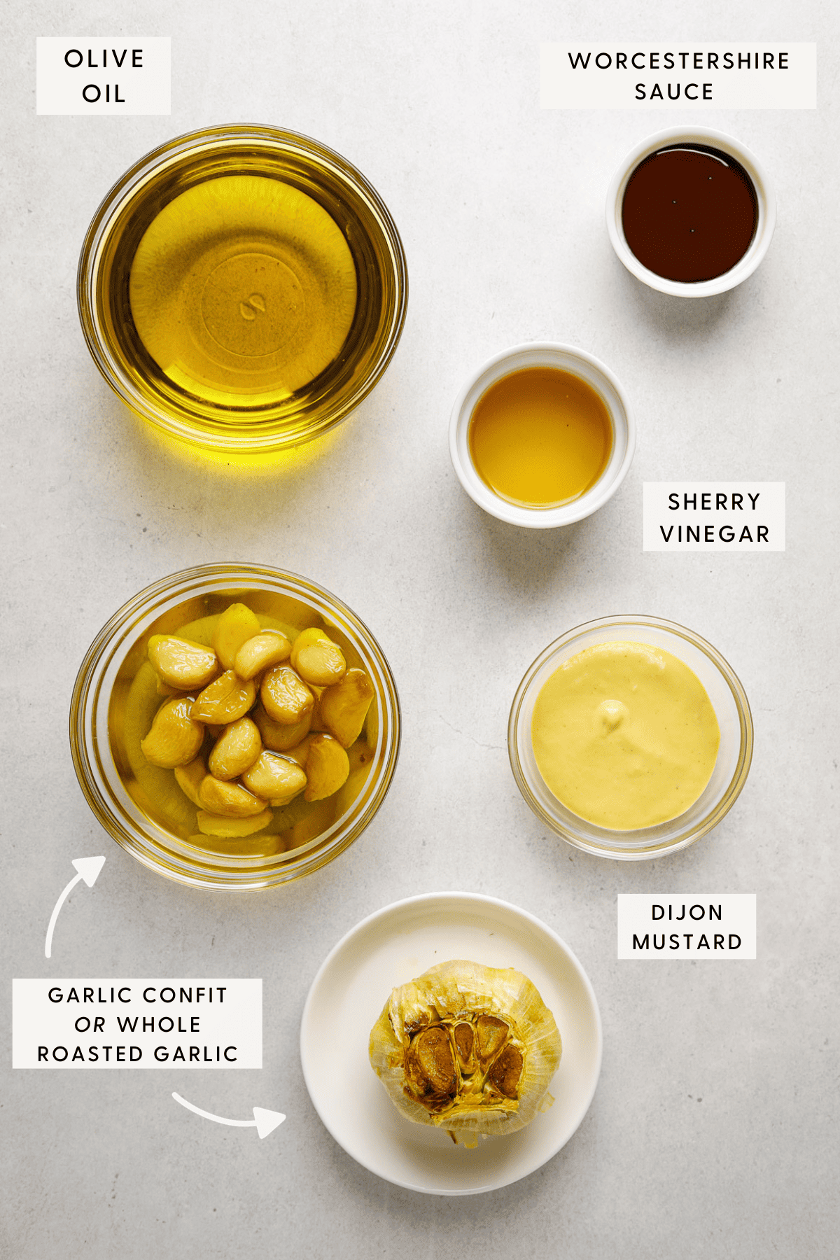 Individual small bowls of roasted garlic, sherry vinegar, dijon mustard and olive oil.