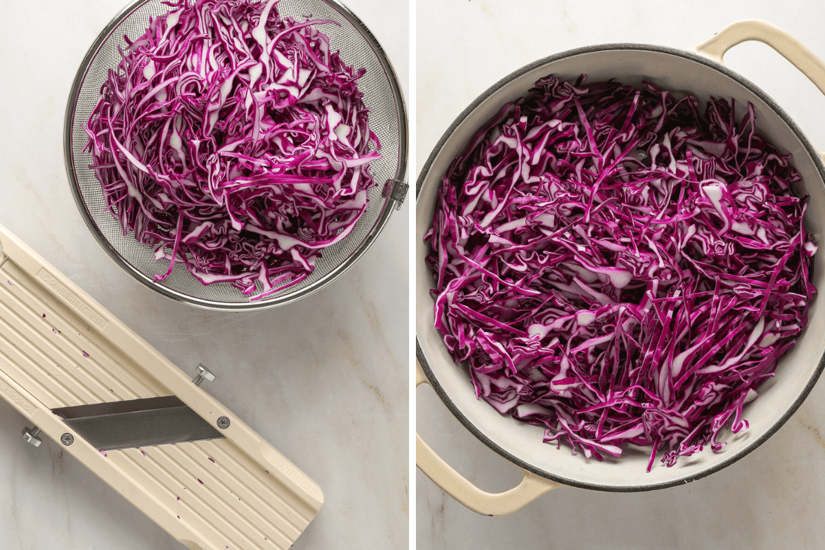 Red cabbage shaved into thin slivers with a beige mandolin slicer off to the side.