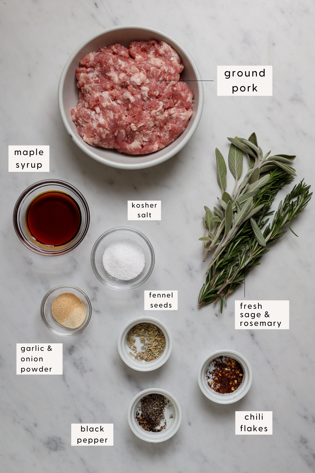 Recipe ingredients individually portioned and labeled on a marble table top.